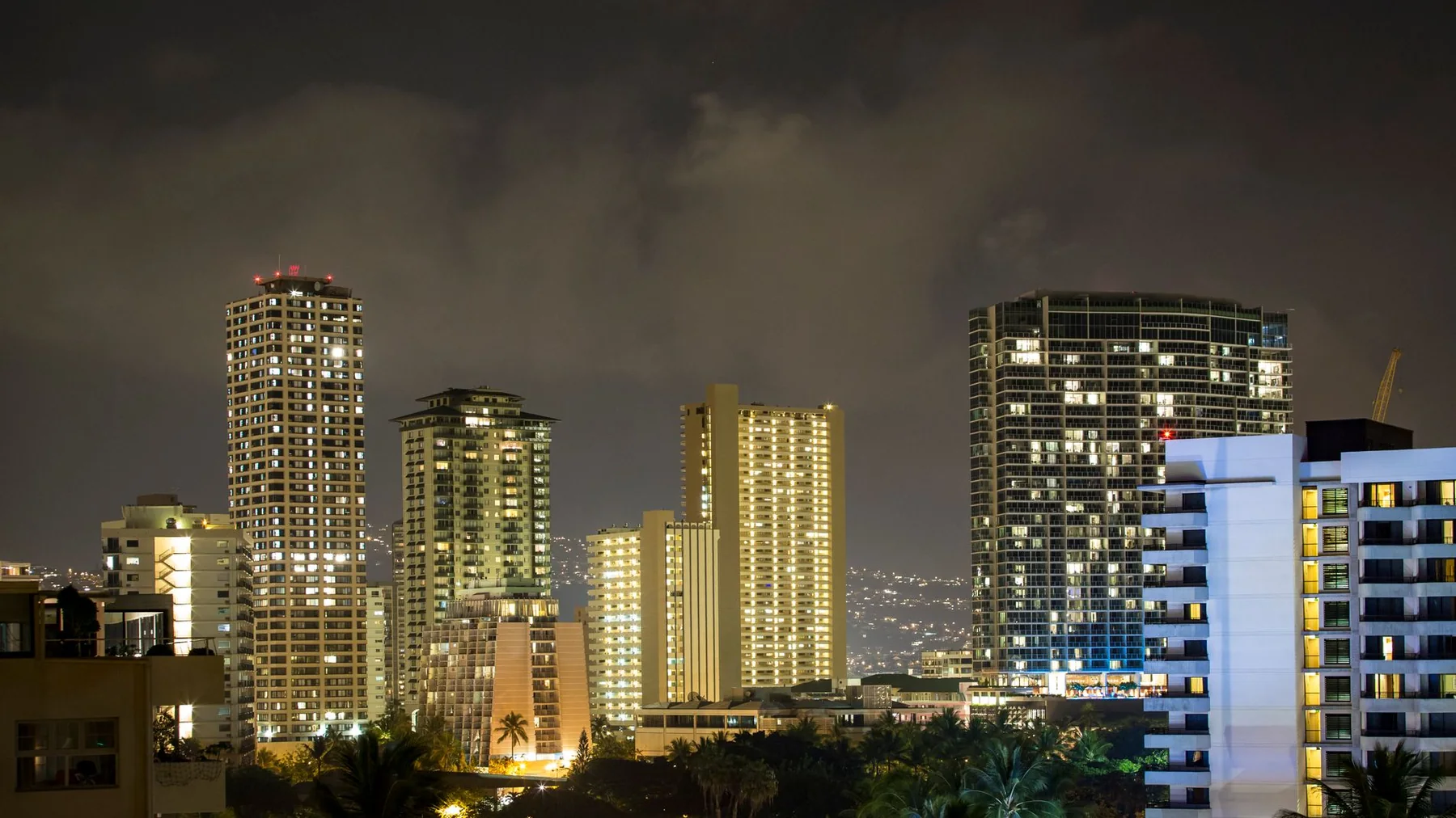Honolulu high-rise hotels lit up against the night sky